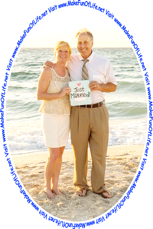 Picture of a happy smiling woman and a happy smiling man standing on a sandy beach with the ocean behind them, holding a card reading, ‘Just Married,’ and the words, ‘Visit www.MakeFunOfLife.net.’