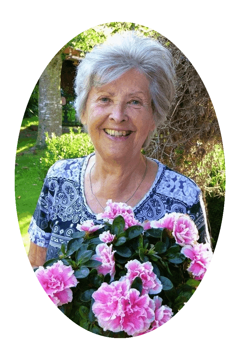 Picture of a woman holding a bouqet of flowers that have pink blossoms with a white fringe.