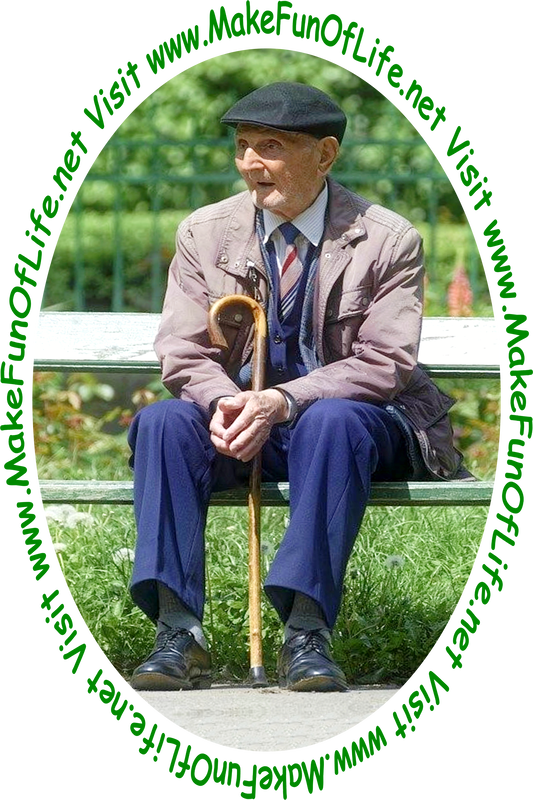 Picture of a man sitting on a wooden bench with his walking cane, and green leafy trees and green grass in the background.