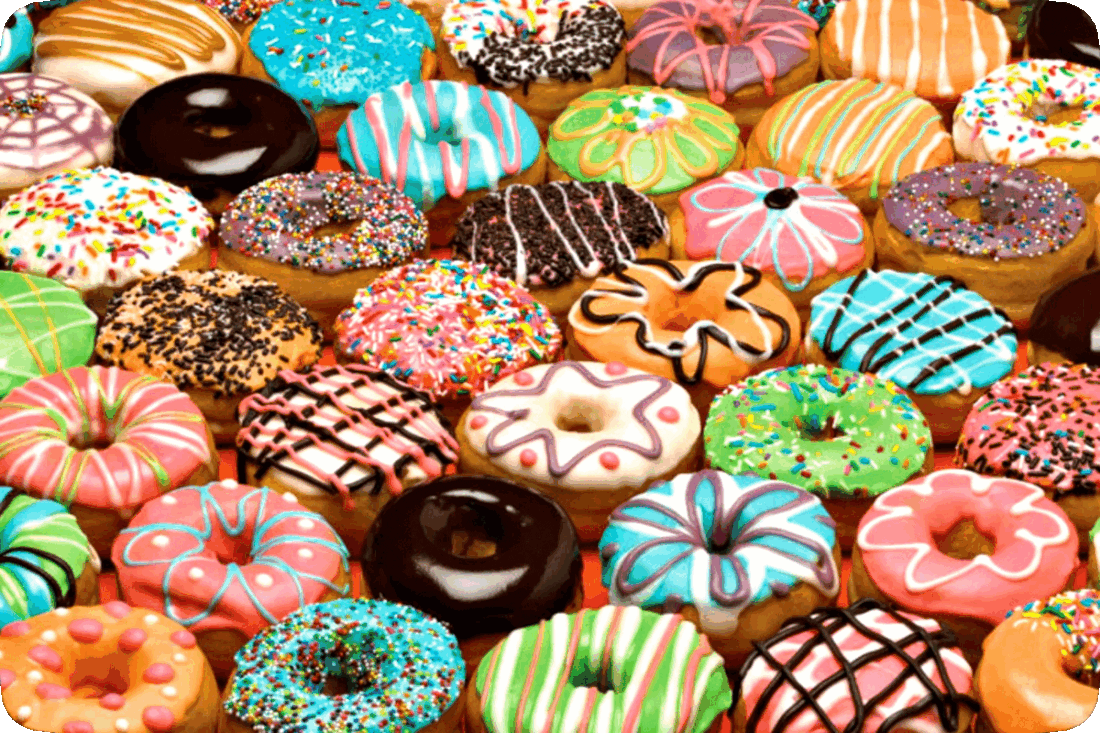 Picture of an assortment of doughnuts with brightly colored glazes and sprinkles.
