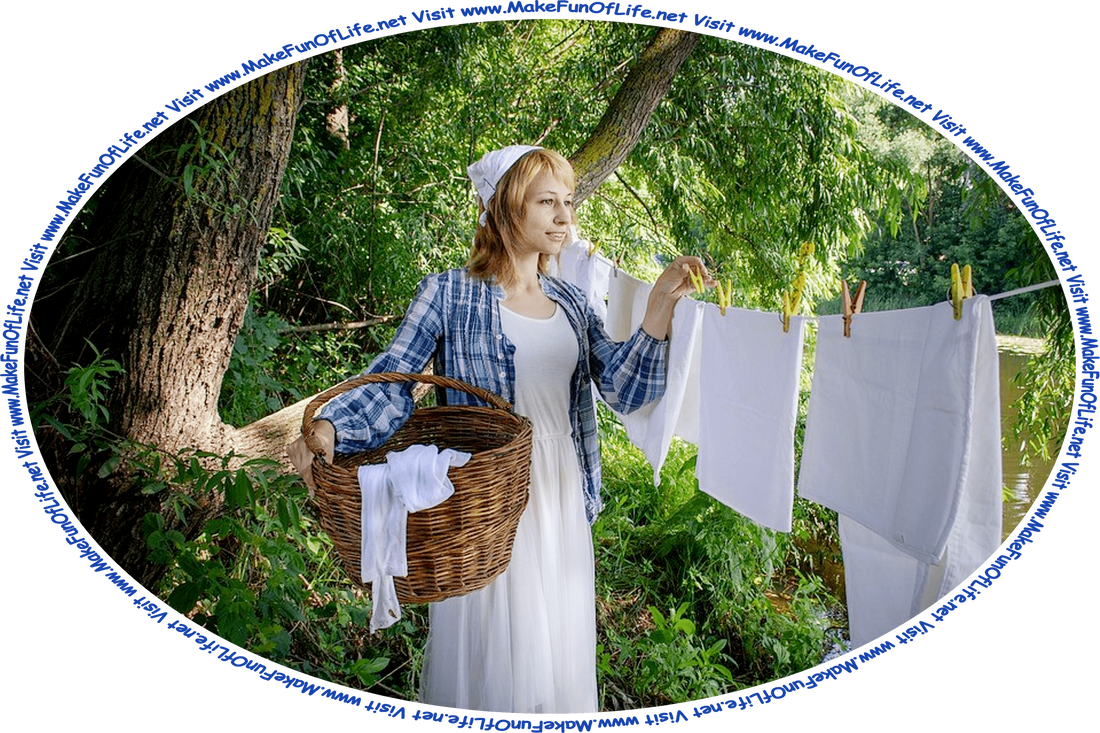 Picture of a woman standing under green leafy trees by a river, removing linens from a clothesline and placing them in a wicker basket, and the words, ‘Visit www.MakeFunOfLife.net.’