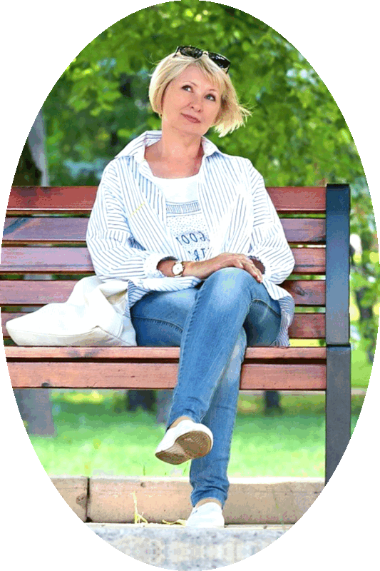 Picture of a woman sitting on a park bench.