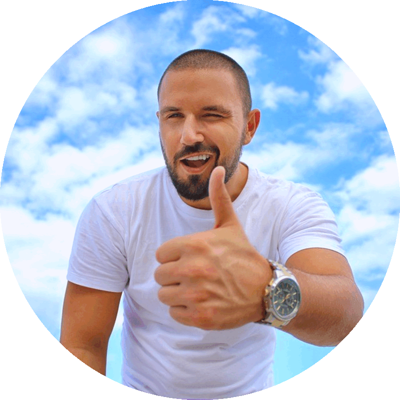 Picture of a happy smiling winking man with thumb up hand gesture and with blue sky and fluffy white clouds in the background.