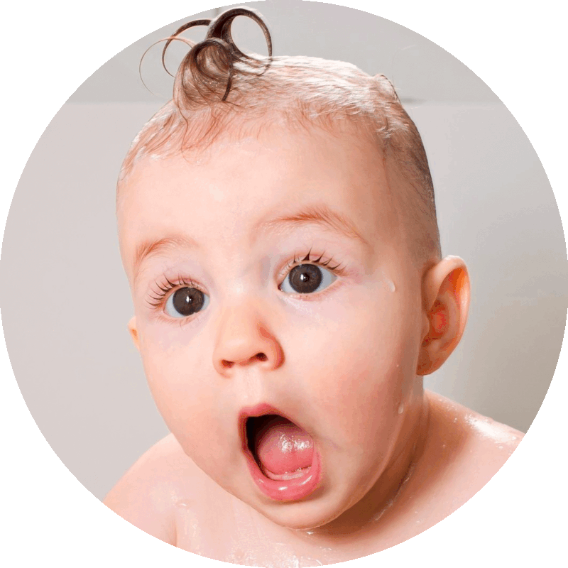 Picture of a baby with a wide-eyed, open-mouth look of astonishment on its face.