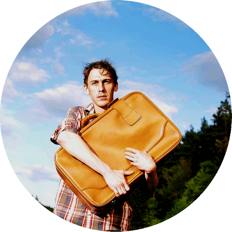 Picture of a young person holding tightly onto a suitcase.