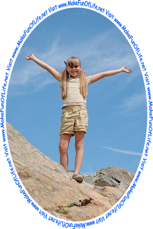 Picture of a happy smiling girl standing outside on top of large rocks, with a slightly hazy blue sky in the background, and the words, 'Visit www.MakeFunOfLife.net.'