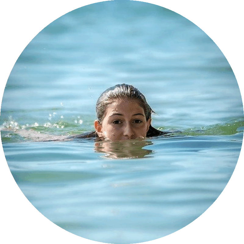 Picture of a woman swimming with her head above the water.