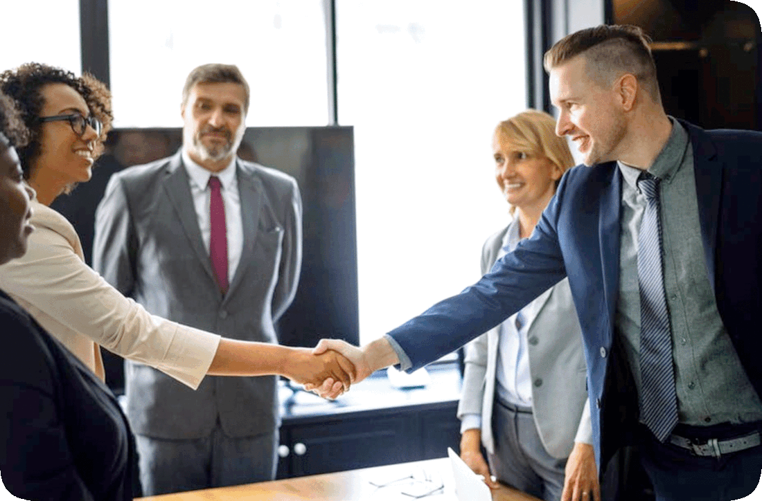 Picture of a group of people dressed for business meeting and shaking hands in an office.