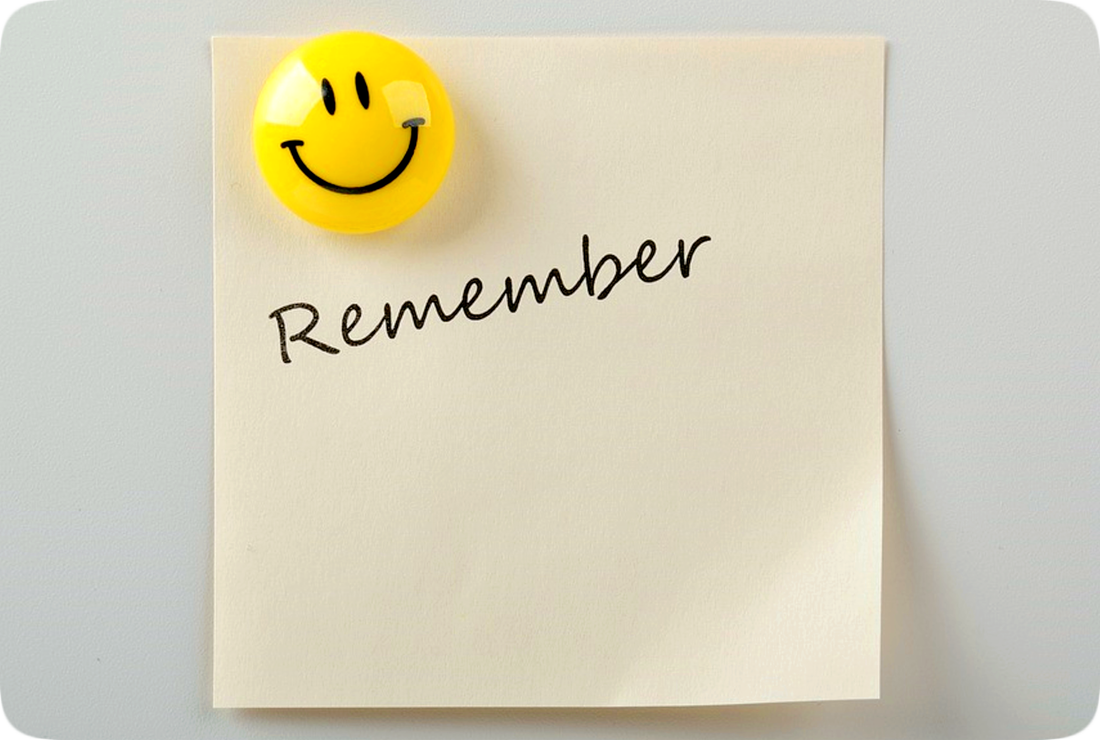 Picture of a square piece of yellow paper with the word Remember written on it, held in place by a bright yellow smiley-face magnet