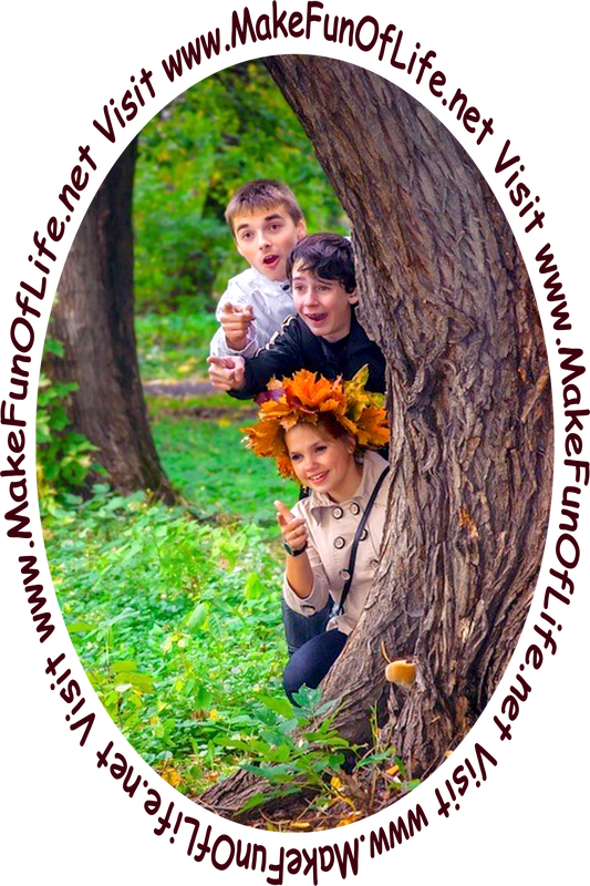 Picture of three happy smiling people peering out from behind a tree trunk.