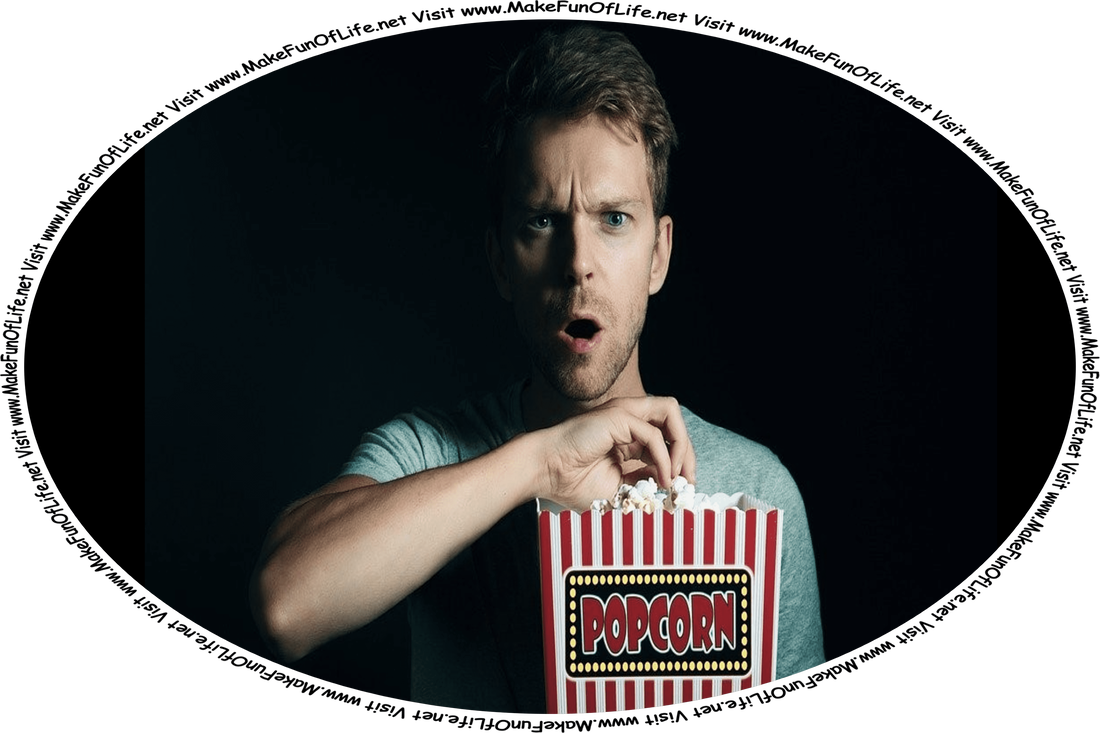 Picture of a man in the dark holding a large box of movie theater popcorn, with an expression of shock and disbelief on his face, and the words, ‘Visit www.MakeFunOfLife.net.’
