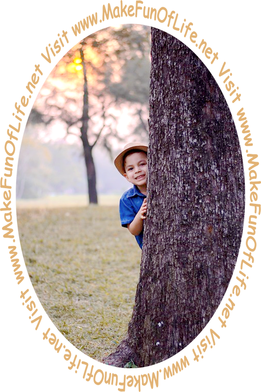 Picture of a boy looking out from behind a tree trunk.
