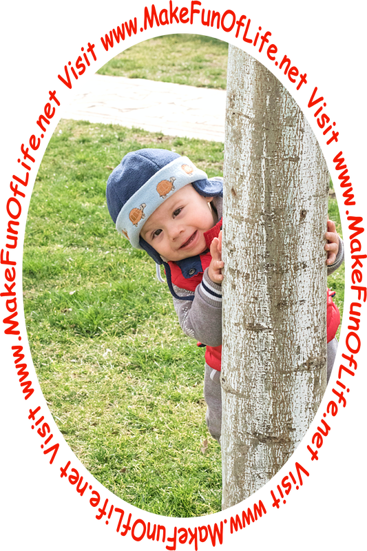 Picture of a happy smiling toddler peeking out from behind a tree.