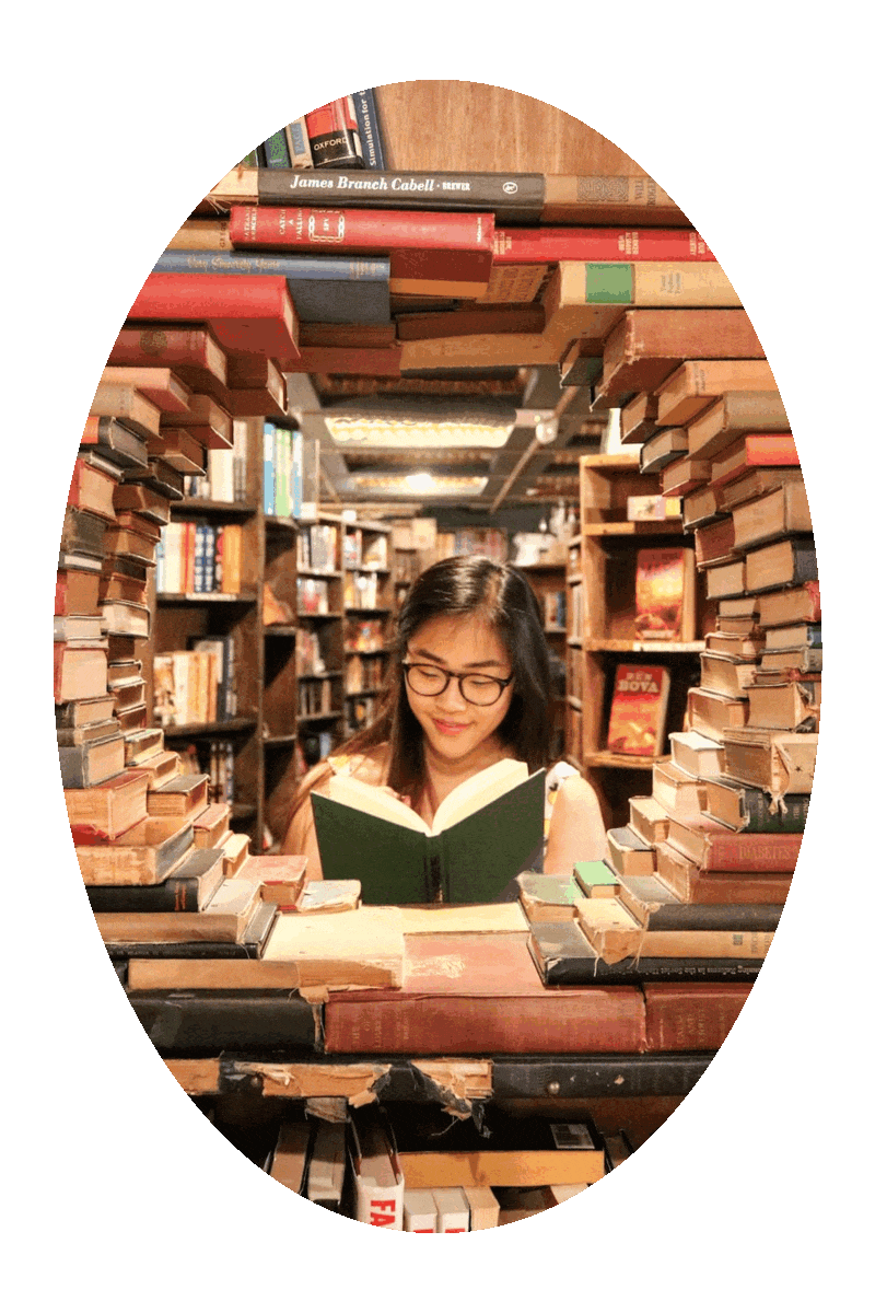 Picture of a woman reading a book in a used book store.
