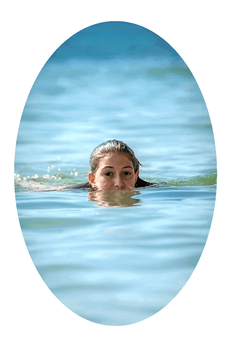 Picture of a woman swimming in water with her head above the water.