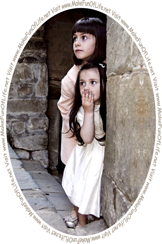 Picture of two girls peering out from the recessed doorway of an old stone building.