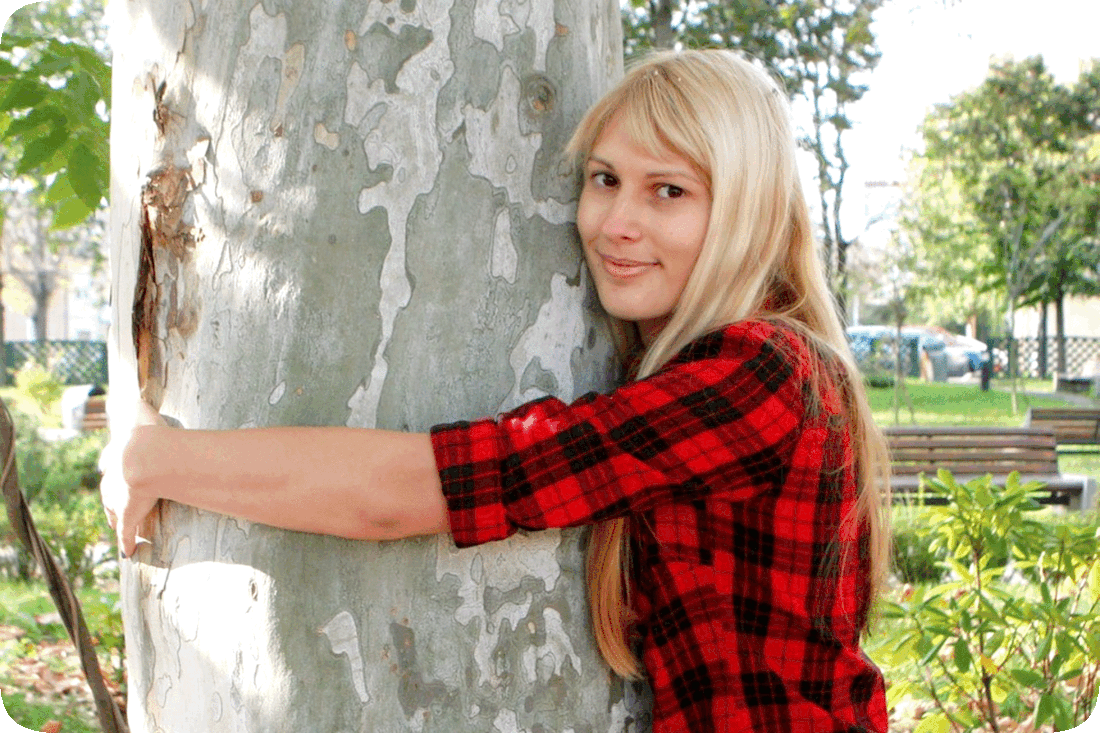 Picture of a woman hugging a tree.
