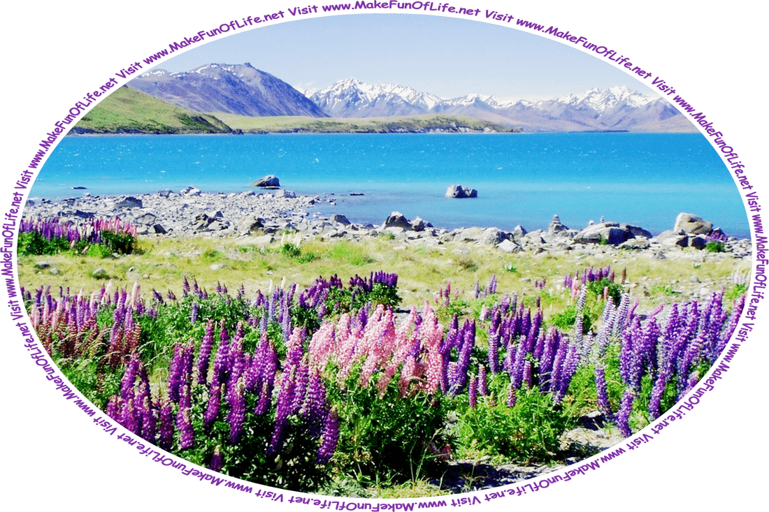 Picture of a blue lake surrounded by flowering plants with pink, lavender, and purple blossoms, and hills and snow-capped mountains in the distance, and the words, ‘Visit www.MakeFunOfLife.net.’