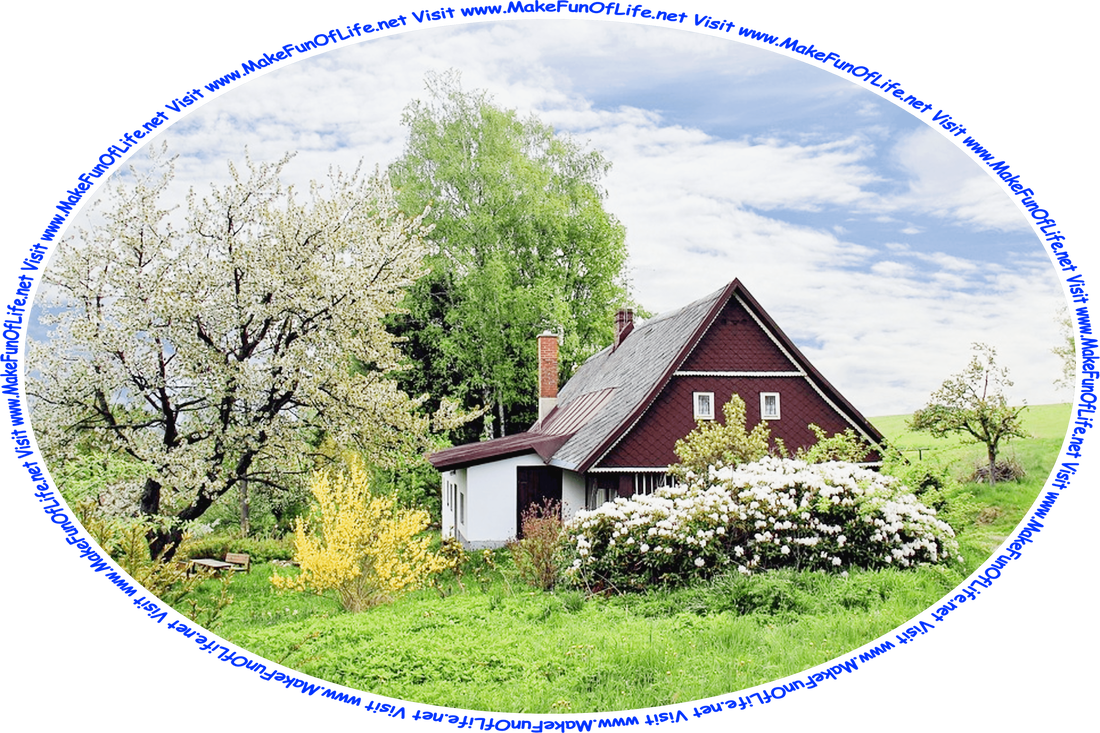 Picture of a country cottage surrounded by flowering trees and bushes and green grass, with a table and benches under a tree a short distance from the cottage door, a blue sky with small fluffy white clouds, and the words, ‘Visit www.MakeFunOfLife.net.’