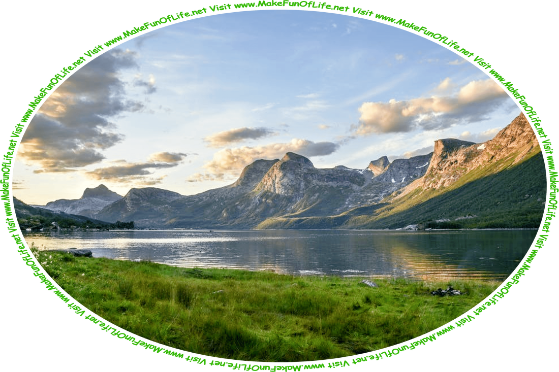 Picture of a calm lake with short green grass on one side and steep mountains on the other side, a cloudy sky above, and the words, ‘Visit www.MakeFunOfLife.net.’