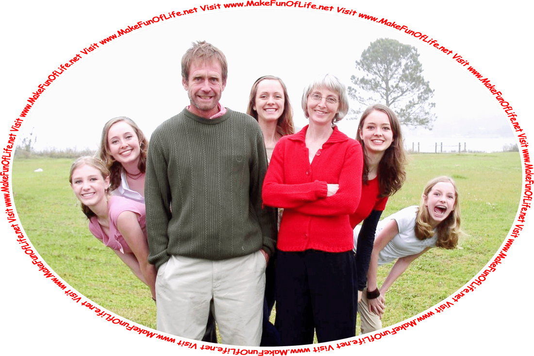 Picture of a family with a mother, father, and five children, all smiling and happy, standing outside in a grassy area with a lake in the background, and the words, ‘Visit www.MakeFunOfLife.net.’