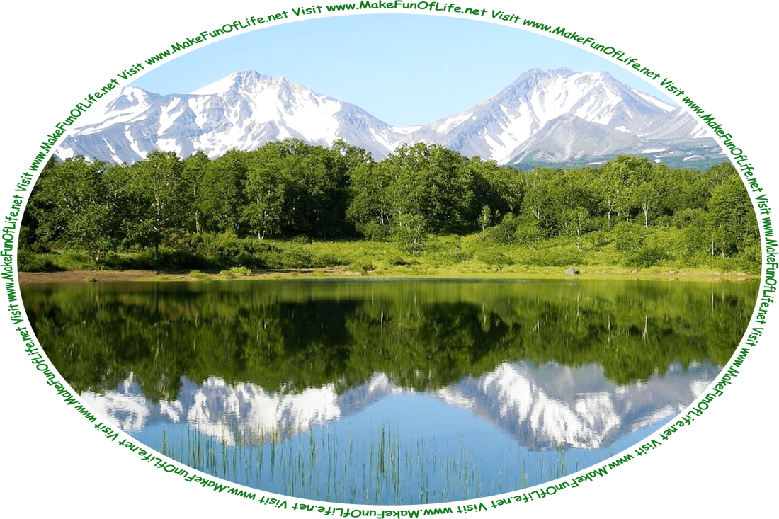 Picture of a lake surrounded by green grass and green leafy trees, with partially snow-covered mountains in the distance, a clear blue sky above, and the words, ‘Visit www.MakeFunOfLife.net.’