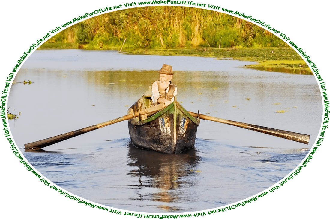 Picture of a man in a boat pulling oars to make the boat move through the water, in a wetlands area with green plants and leafy green trees at the water’s edge, an overcast sky above, and the words, ‘Visit www.MakeFunOfLife.net.’